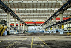 Expansive industrial warehouse interior showcasing steel framework and spacious layout for diverse manufacturing needs.